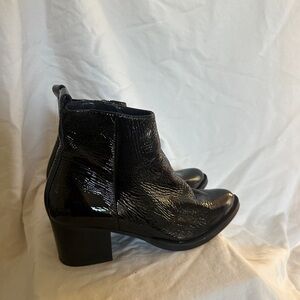 Intentionally blank black patent leather ankle boots